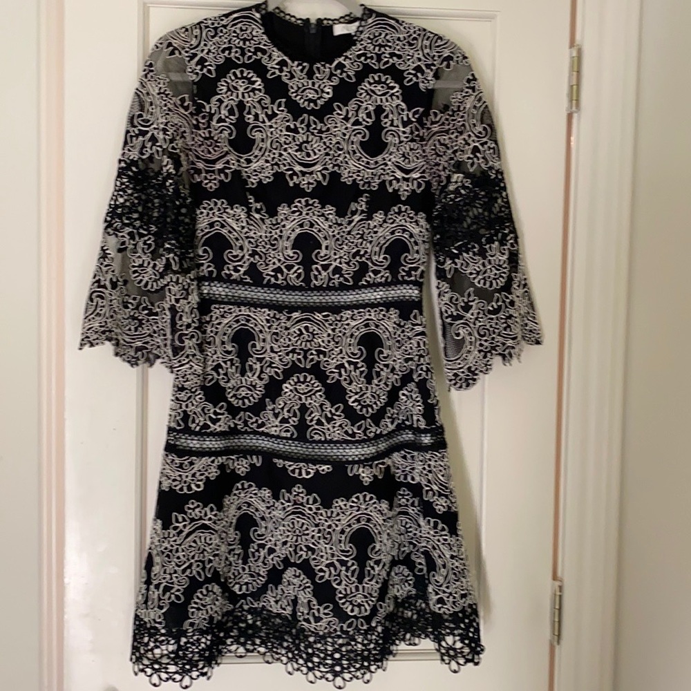 Beautiful black lace dress with white details.  Excellent condition.